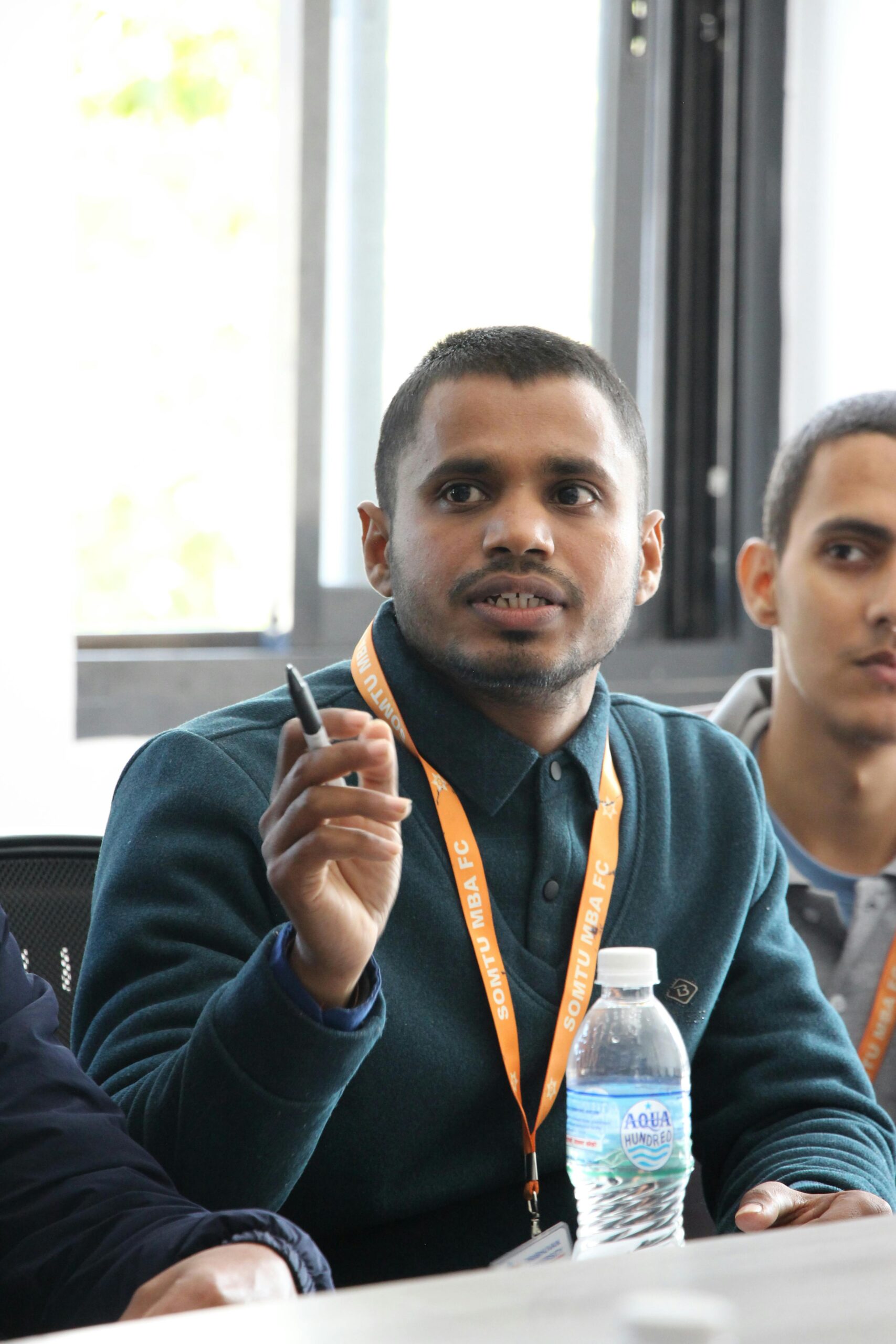 University students actively participating in a seminar, discussing finance and management topics.